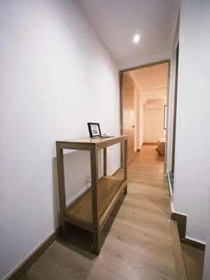 a hallway with a wooden table in a room at Apartamento frente al mar in Cartagena de Indias