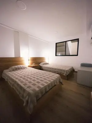 a hotel room with two beds and a window at Apartamento frente al mar in Cartagena de Indias