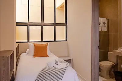 a small bedroom with a bed and a window at Casa Maguey – Refugio Tropical en el Centro de Cartagena in Cartagena de Indias