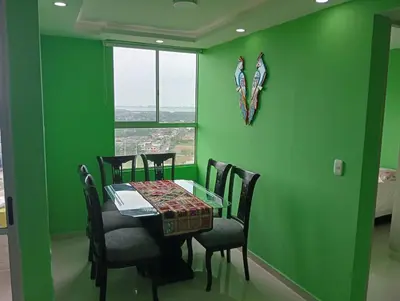 a green dining room with a table and chairs at Live in the Heights Fresh and Bright Apartment in Cartagena de Indias