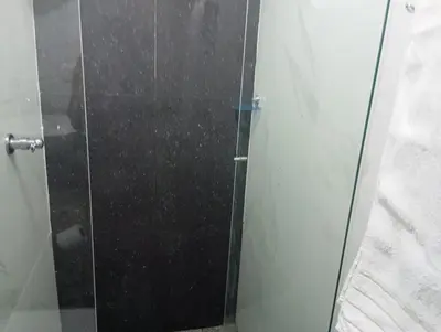 a shower stall with a glass door in a bathroom at Live in the Heights Fresh and Bright Apartment in Cartagena de Indias