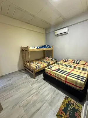 a room with two beds and a rug at Villa Ana tu hogar lejos de casa in Coveñas