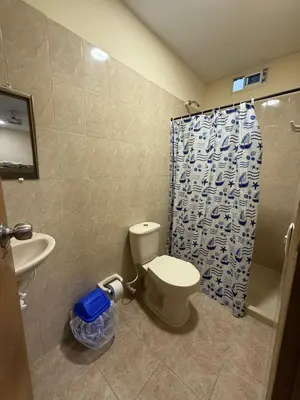 a bathroom with a toilet and a sink and a shower at Villa Ana tu hogar lejos de casa in Coveñas