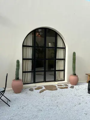 a room with two cactuses in front of a window at Villa Privada con Piscina - Playas del Atlantico in Tubará