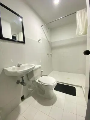 a white bathroom with a toilet and a sink at Apartamento para Grupos En La Boquilla BBB in Cartagena de Indias