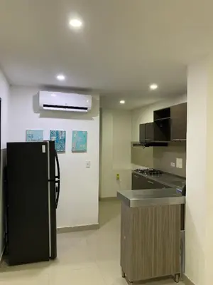 a kitchen with a black refrigerator and a counter at Apartamento para Grupos En La Boquilla BBB in Cartagena de Indias