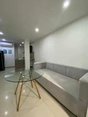 a living room with a couch and a glass table at Apartamento Para 6 Pax En La Boquilla VIAMAR in Cartagena de Indias