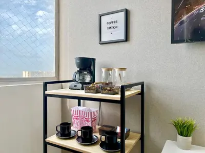 a shelf with a coffee maker on top of it at Relax with a views, massage chairs and coffee station in Barranquilla