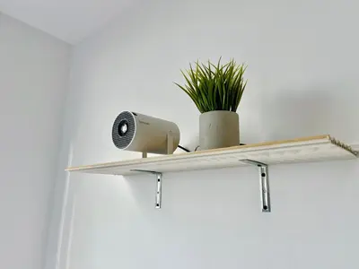 a shelf with a speaker and a plant on it at Relax with a views, massage chairs and coffee station in Barranquilla