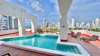 a swimming pool on top of a building with a city at Apto luxury en el laguito edificio marina del rey cartagena frente al mar in Cartagena de Indias