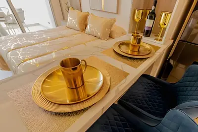 a dining table with a gold plate on it next to a bed at Nueva, Lujosa y Exclusiva Suite Vista al Mar in Cartagena de Indias