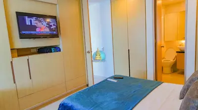 a bedroom with a tv and a bed and a bathroom at Apto Vista Laguito y Mar Piso 21 in Cartagena de Indias