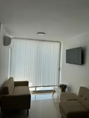 a living room with a couch and a chair at VISTA CARIBE- apartamento piso 25, marbella in Cartagena de Indias