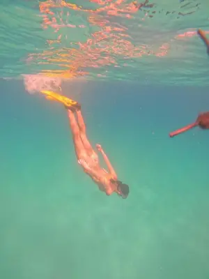a person swimming in the water at CARDUMEN Arte y Cocina in Playa Blanca