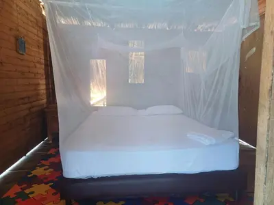 a bed in a room with a mosquito net at CARDUMEN Arte y Cocina in Playa Blanca