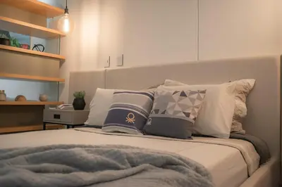 a bed with pillows on it in a bedroom at Suite 1010 - Ocean View - Distrito90 in Barranquilla