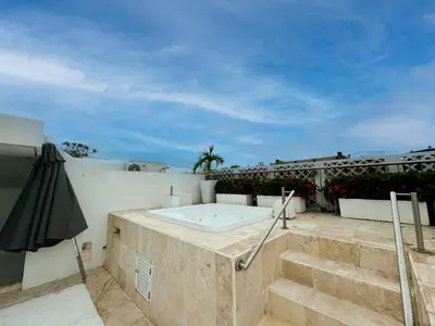 a patio with an umbrella and a hot tub at Incredible 2BR with AC in Ciudad Amurallada in Cartagena de Indias