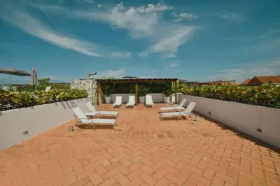 a group of chairs sitting on a brick patio at Incredible 2BR with AC in Ciudad Amurallada in Cartagena de Indias