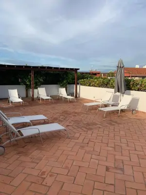 a group of chairs and umbrellas on a patio at Incredible 2BR with AC in Ciudad Amurallada in Cartagena de Indias