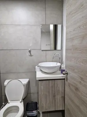 a bathroom with a white toilet and a sink at Alojamiento Nuevo en Piso 24 con WiFi Rápido y Vista al Mar, Cerca al Centro Histórico in Cartagena de Indias