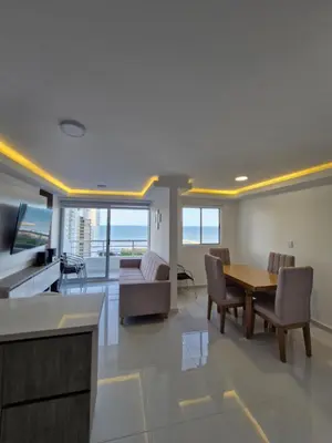 a kitchen and living room with a table and chairs at Alojamiento Nuevo en Piso 24 con WiFi Rápido y Vista al Mar, Cerca al Centro Histórico in Cartagena de Indias