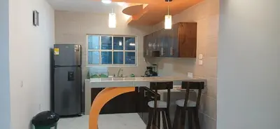 a kitchen with a sink and a refrigerator at Hospedaje MangleRojo - Cerca al Mar in Coveñas