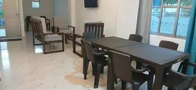 a dining room with a table and chairs at Hospedaje MangleRojo - Cerca al Mar in Coveñas