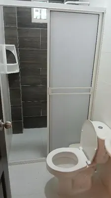 a bathroom with a white toilet and a shower at Hospedaje MangleRojo - Cerca al Mar in Coveñas