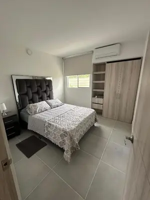 a bedroom with a large bed with a large headboard at Cartagena Vibes-Apartamento Serena del Mar in Cartagena de Indias