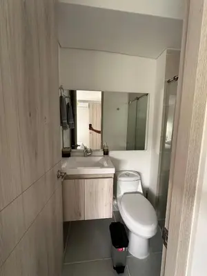 a bathroom with a sink and a toilet and a mirror at Cartagena Vibes-Apartamento Serena del Mar in Cartagena de Indias