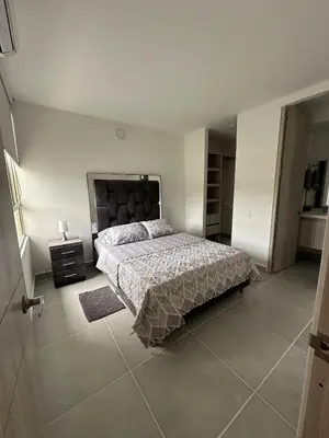 a bedroom with a bed in a white room at Cartagena Vibes-Apartamento Serena del Mar in Cartagena de Indias