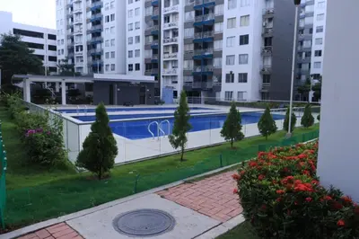 a swimming pool in a city with tall buildings at Hermoso apartamento en Miramar in Barranquilla