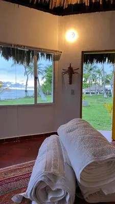a bed in a room with a bug on the wall at Punta Manzanillo in San Bernardo del Viento