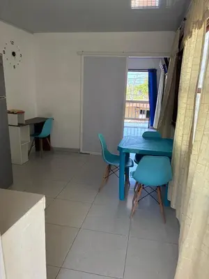 a dining room with a blue table and chairs at Apartaestudio Sara en Coveñas in Coveñitas