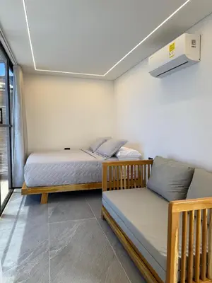 a bedroom with two beds and a couch in it at Luxury Suite frente de Mar Piscina Restaurante y Bar in San Silvestre