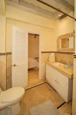 a bathroom with a toilet and a sink and a mirror at Niña Maria pool House Plaza San Diego, Downtown! in Cartagena de Indias