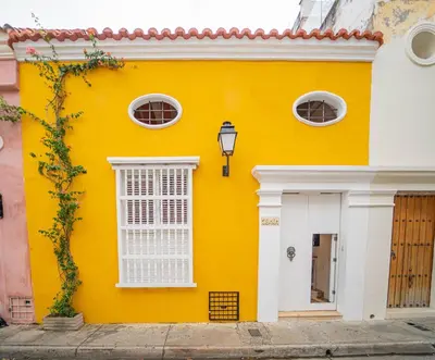 a yellow building with white windows and a street at Niña Maria pool House Plaza San Diego, Downtown! in Cartagena de Indias