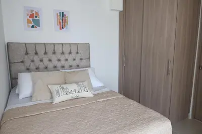 a bed with two pillows on top of it at Piso 32 Vista al mar y centro histórico in Cartagena de Indias