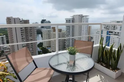 a balcony with a glass table and two chairs at Piso 32 Vista al mar y centro histórico in Cartagena de Indias
