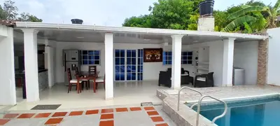 a villa with a swimming pool and a house at Hotel Roy in Santa Marta