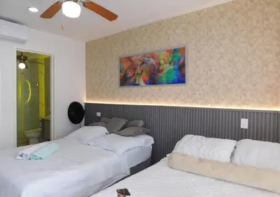 a bedroom with two beds and a painting on the wall at Apartamento Morros 3 Cartagena, Piscina Playa y Mar in Cartagena de Indias