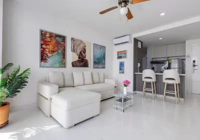 a white living room with a couch and a table at Apartamento Morros 3 Cartagena, Piscina Playa y Mar in Cartagena de Indias