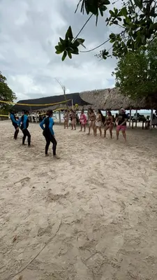 a group of people dancing on the beach at Dorado Beach Isla in Playa Punta Arena