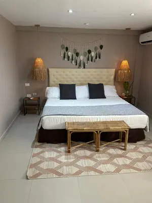 a large bedroom with a large bed and a rug at Dorado Beach Isla in Playa Punta Arena