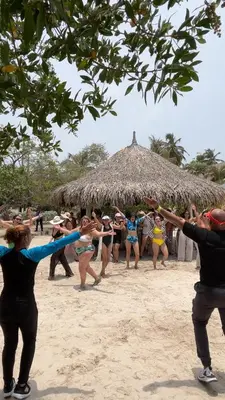 a group of people dancing on the beach at Dorado Beach Isla in Playa Punta Arena