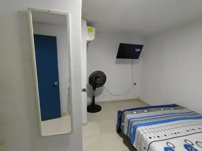 a small room with a mirror and a bed at Casa Angie in Cartagena de Indias