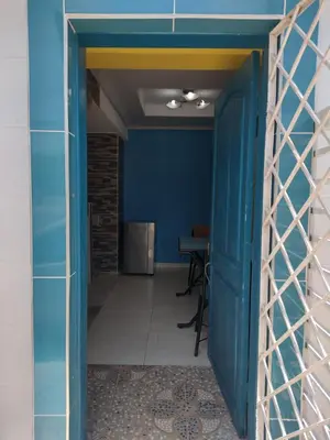 an open door into a hallway with a blue wall at Casa Angie in Cartagena de Indias