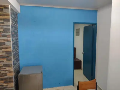 a blue wall in a room with a door at Casa Angie in Cartagena de Indias