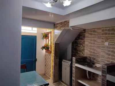 a kitchen with a sink and a brick wall at Casa Angie in Cartagena de Indias