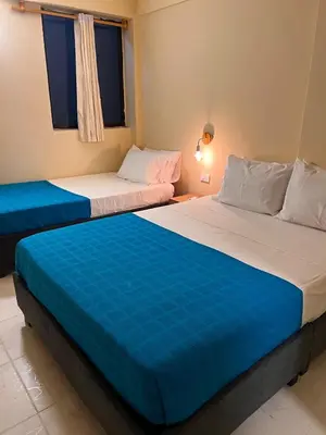 two beds sitting next to each other in a room at Alma Del Mar in Cartagena de Indias